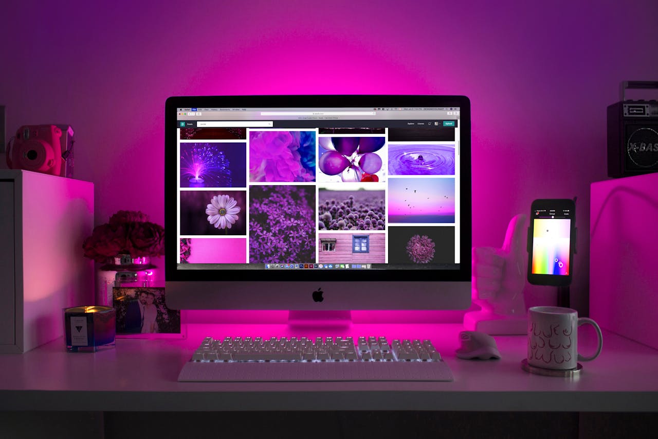our-journey-02 Modern desk setup with neon lighting and a desktop computer displaying colorful images.