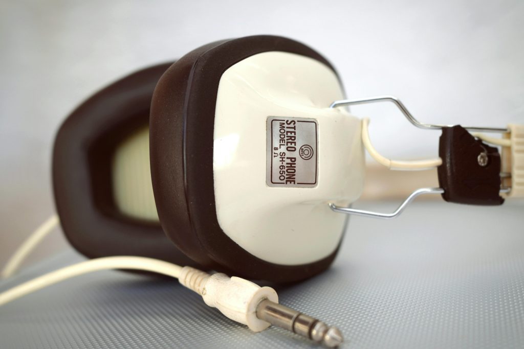 Close-up of classic stereo headphones with a retro design and an attached jack plug.