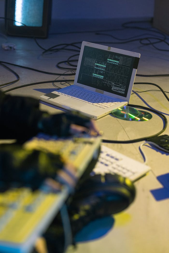 about-me-01 Laptop with coding software on-screen, symbolizing cybersecurity and tech innovation.